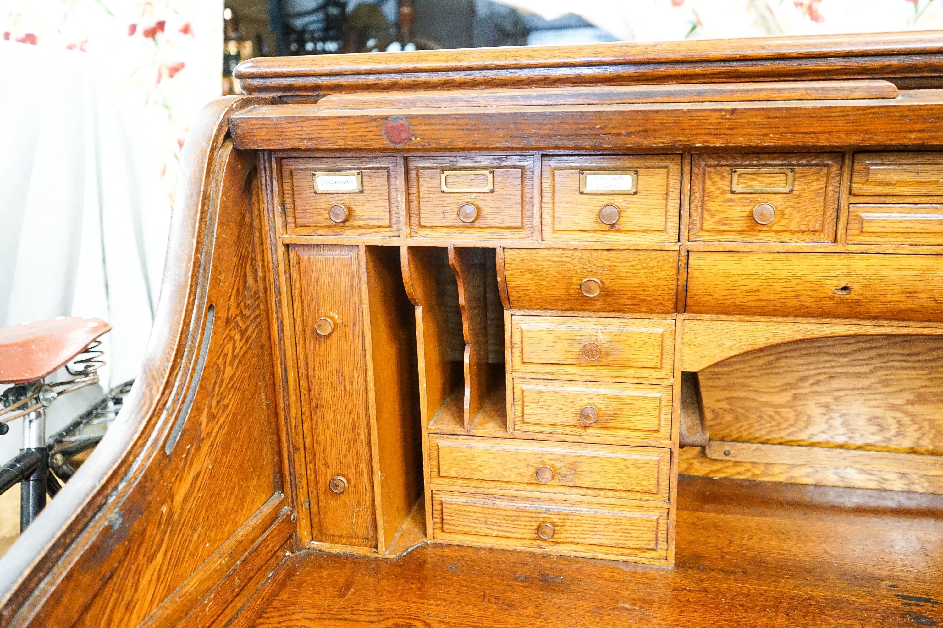 An early 20th century oak roll top desk with 'S' shape tambour, width 140cm, depth 80cm, height 128cm